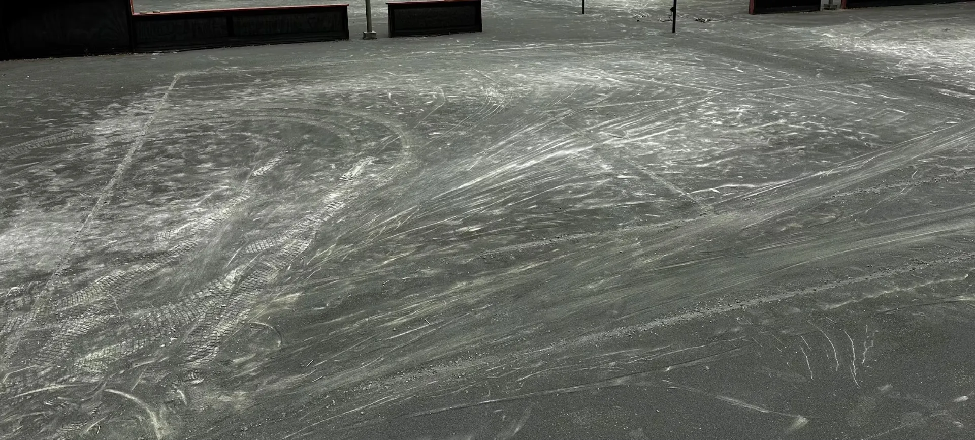 Working marks and texture across a court surface.